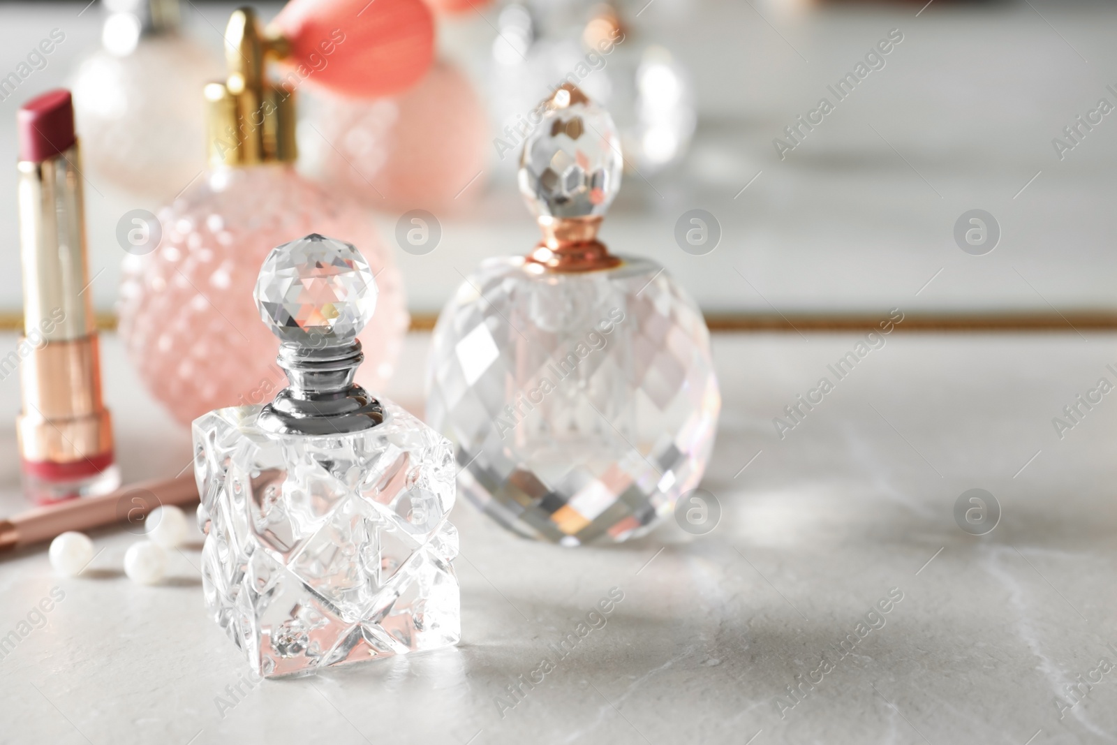 Photo of Different perfume bottles on dressing table, space for text