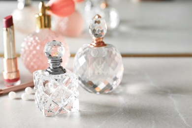 Photo of Different perfume bottles on dressing table, space for text