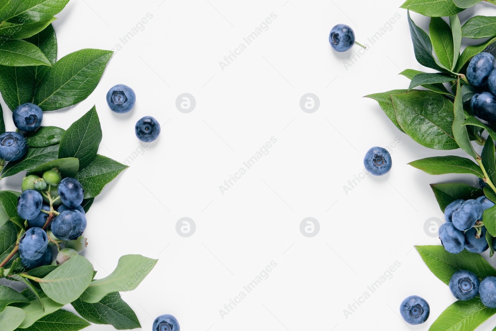 Photo of Tasty fresh blueberries with green leaves on white background, flat lay. Space for text