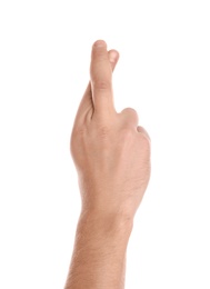 Man showing hand with crossed fingers on white background, closeup