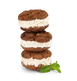 Photo of Sweet delicious ice cream cookie sandwiches and mint on white background