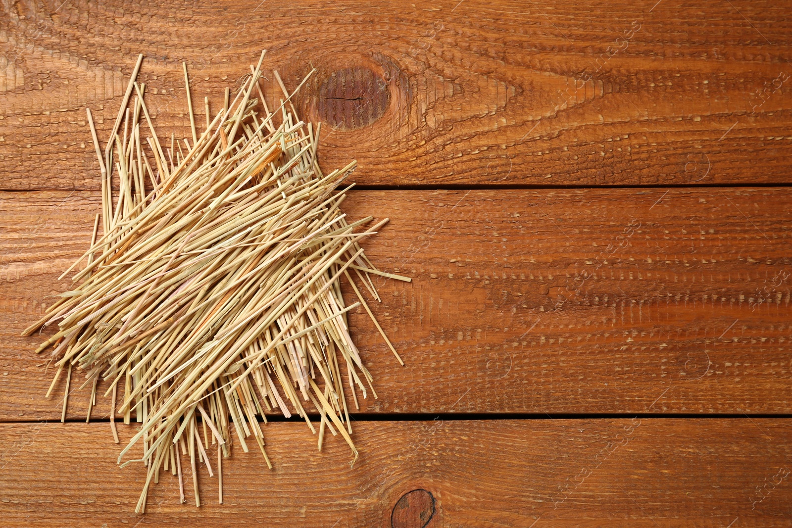 Photo of Dried hay on wooden background, top view. Space for text