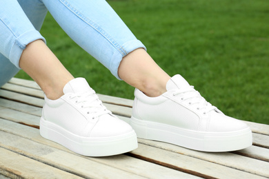 Photo of Woman wearing comfortable stylish shoes outdoors, closeup