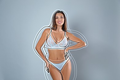 Beautiful slim woman after weight loss on light grey background 