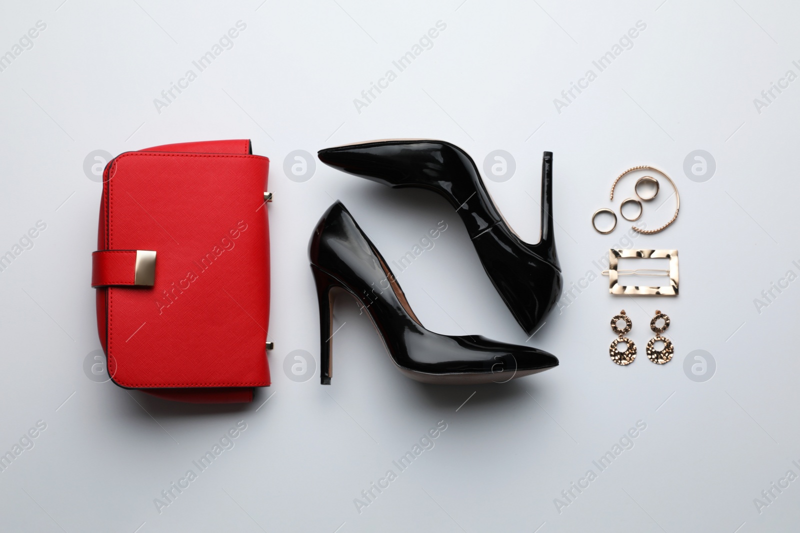 Photo of Stylish woman's bag, shoes and bijouterie on light background, flat lay