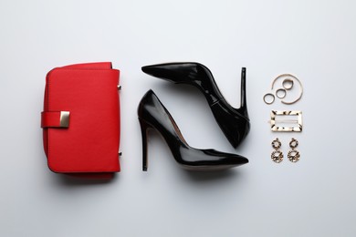 Photo of Stylish woman's bag, shoes and bijouterie on light background, flat lay