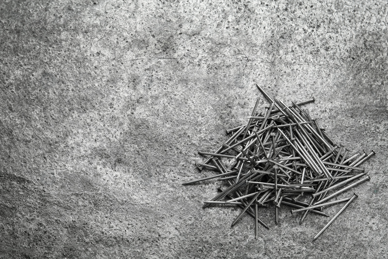 Photo of Many metal nails on grey background, flat lay. Space for text