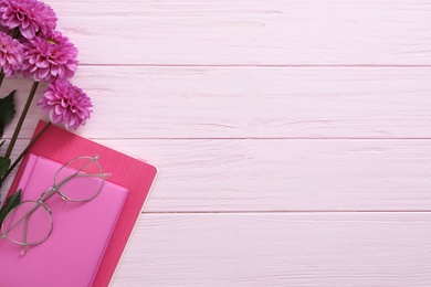 Beautiful flowers and stationery on pink wooden background, flat lay with space for text. Teacher's Day