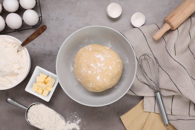Fresh dough and different ingredients for making baklava on grey table, flat lay