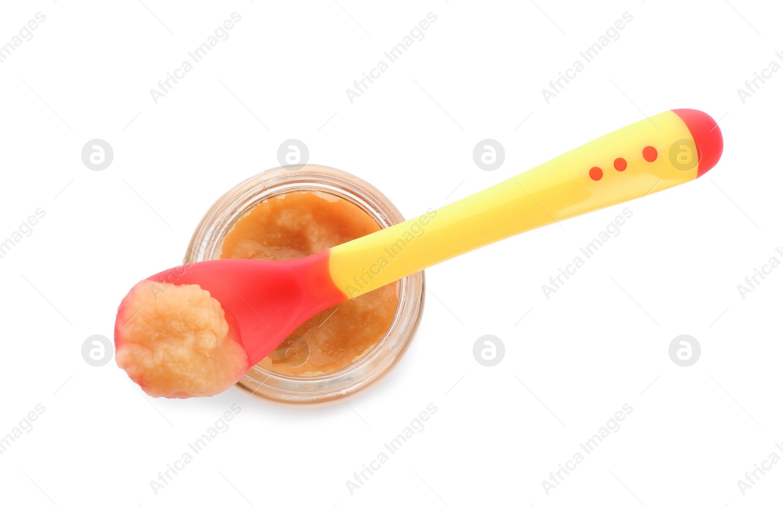 Photo of Jar and spoon with healthy baby food on white background, top view