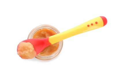 Photo of Jar and spoon with healthy baby food on white background, top view