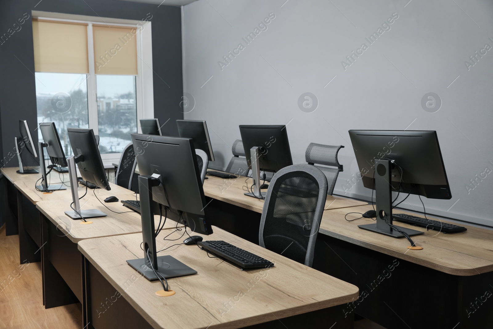 Photo of Many modern computers in open space office