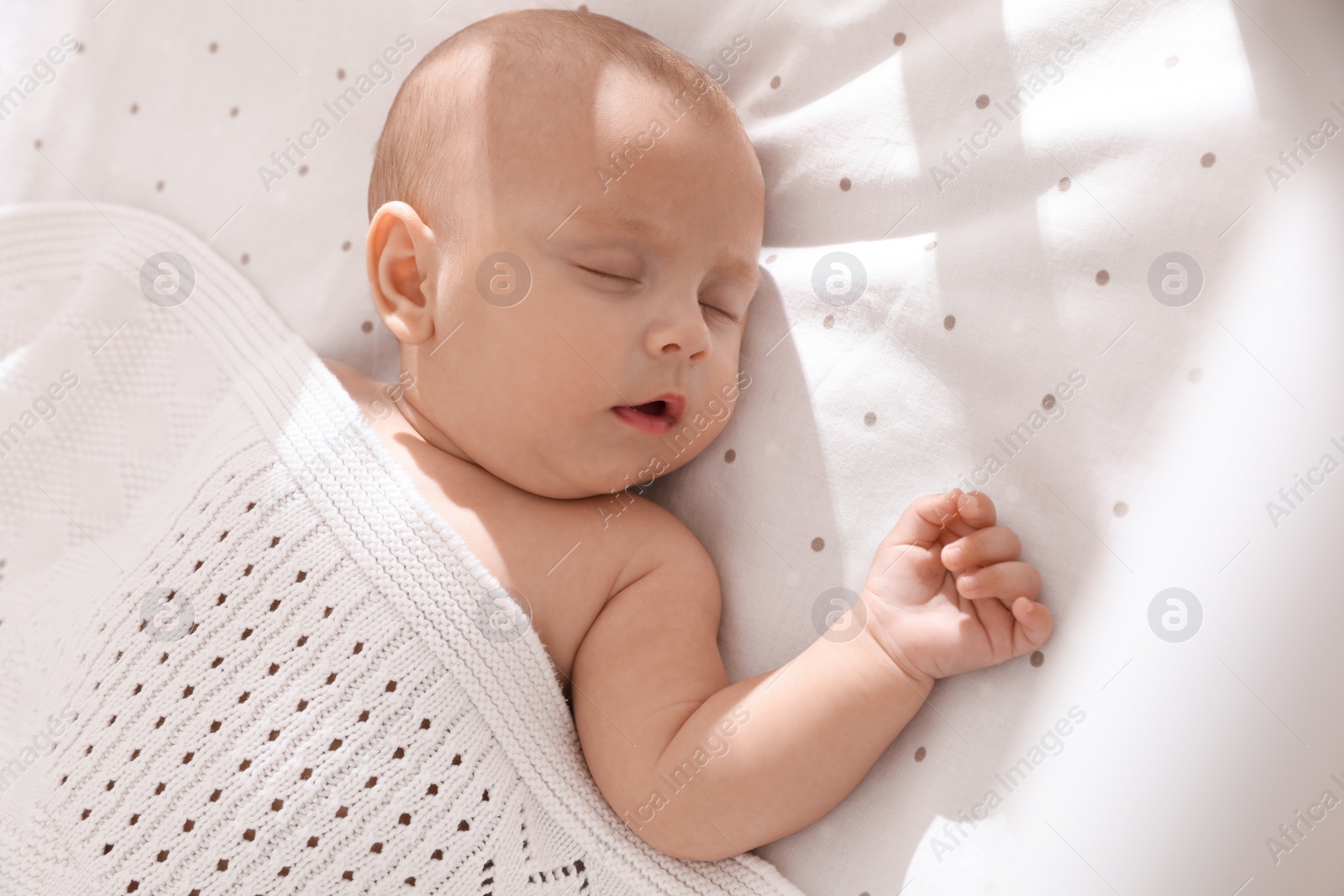Photo of Cute little baby sleeping in bed, above view