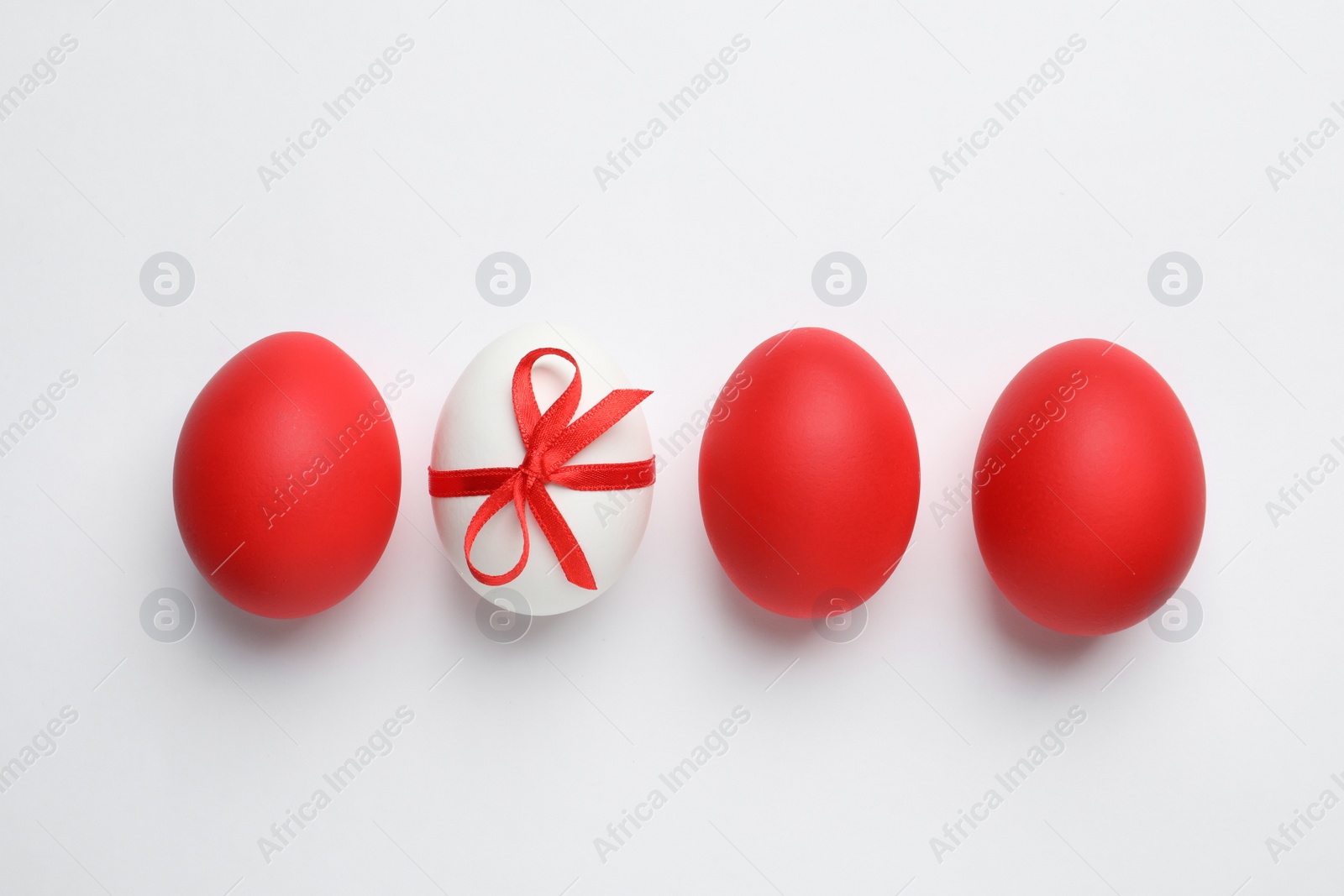 Photo of Composition of painted red Easter eggs on white background, top view