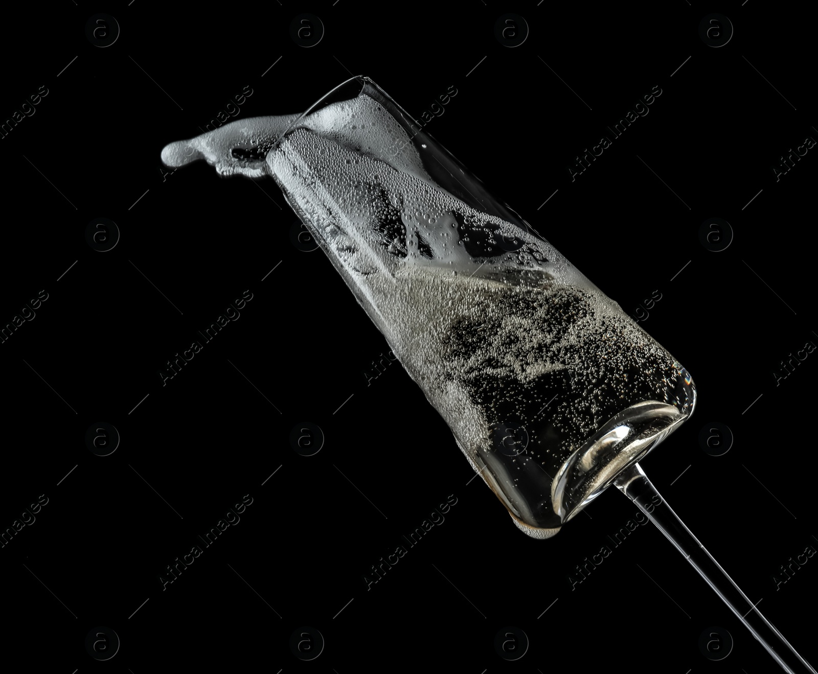 Photo of Glass of champagne on black background. Festive drink