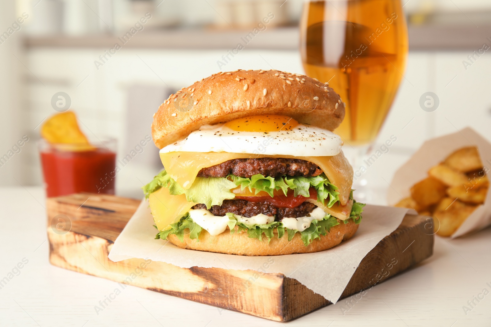 Photo of Tasty burger with fried egg on wooden board