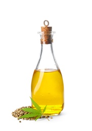 Bottle with hemp oil, leaf and seeds on white background