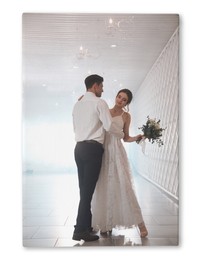 Photo printed on canvas, white background. Happy newlywed couple dancing together in festive hall