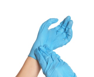 Doctor wearing medical gloves on white background