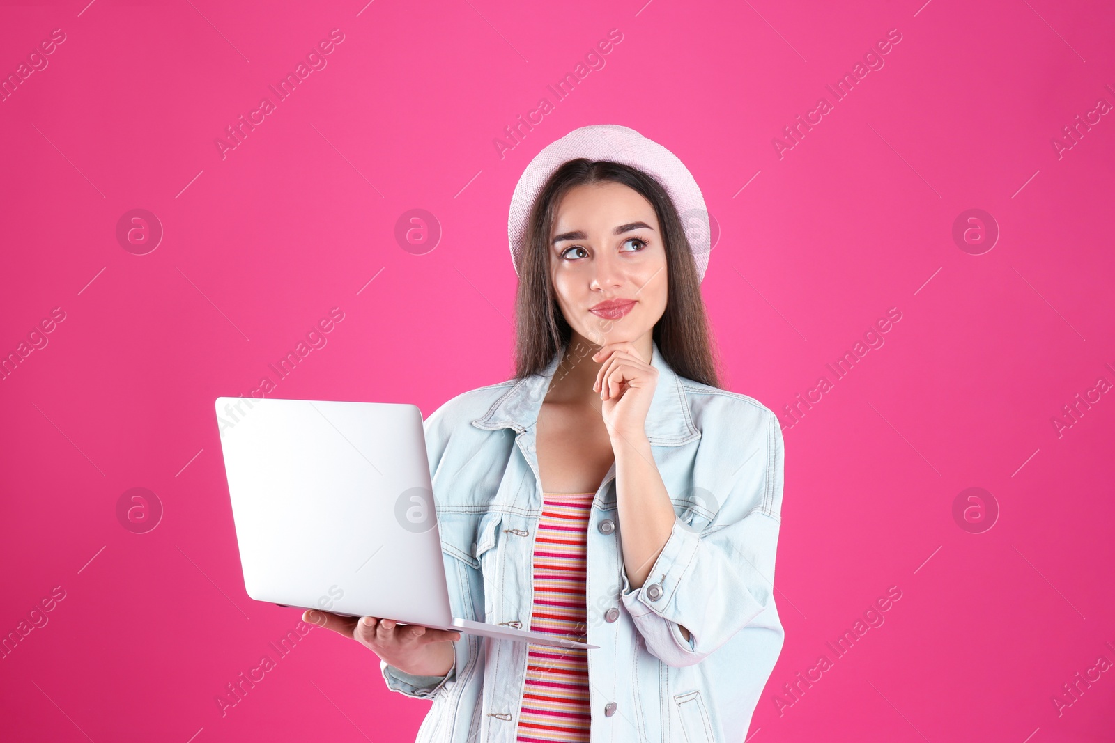 Photo of Portrait of young woman in casual outfit with laptop on color background