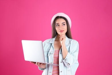 Photo of Portrait of young woman in casual outfit with laptop on color background