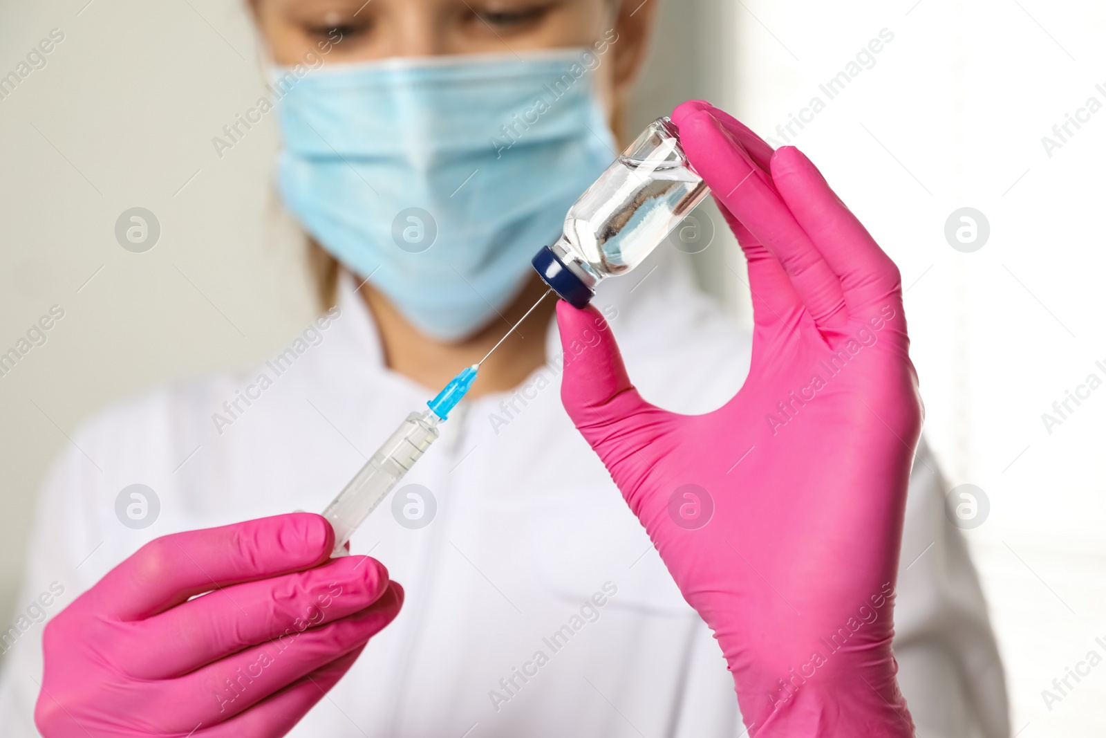 Photo of Doctor with vial and syringe in hospital, closeup. Vaccination day
