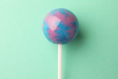 Photo of Tasty lollipop on turquoise background, top view