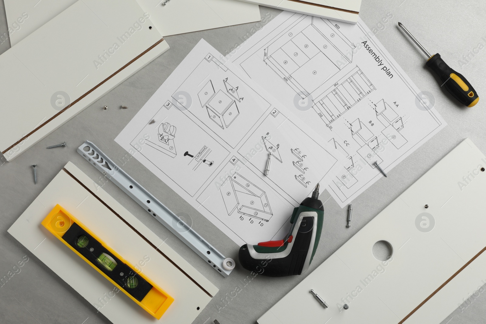 Photo of Flat lay composition with furniture parts and tools for self-assembly on grey background