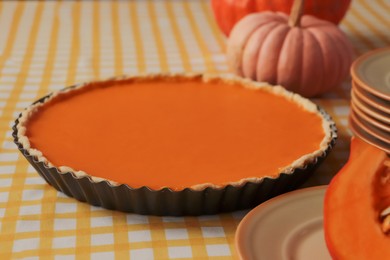 Photo of Delicious homemade pumpkin pie in baking dish on table