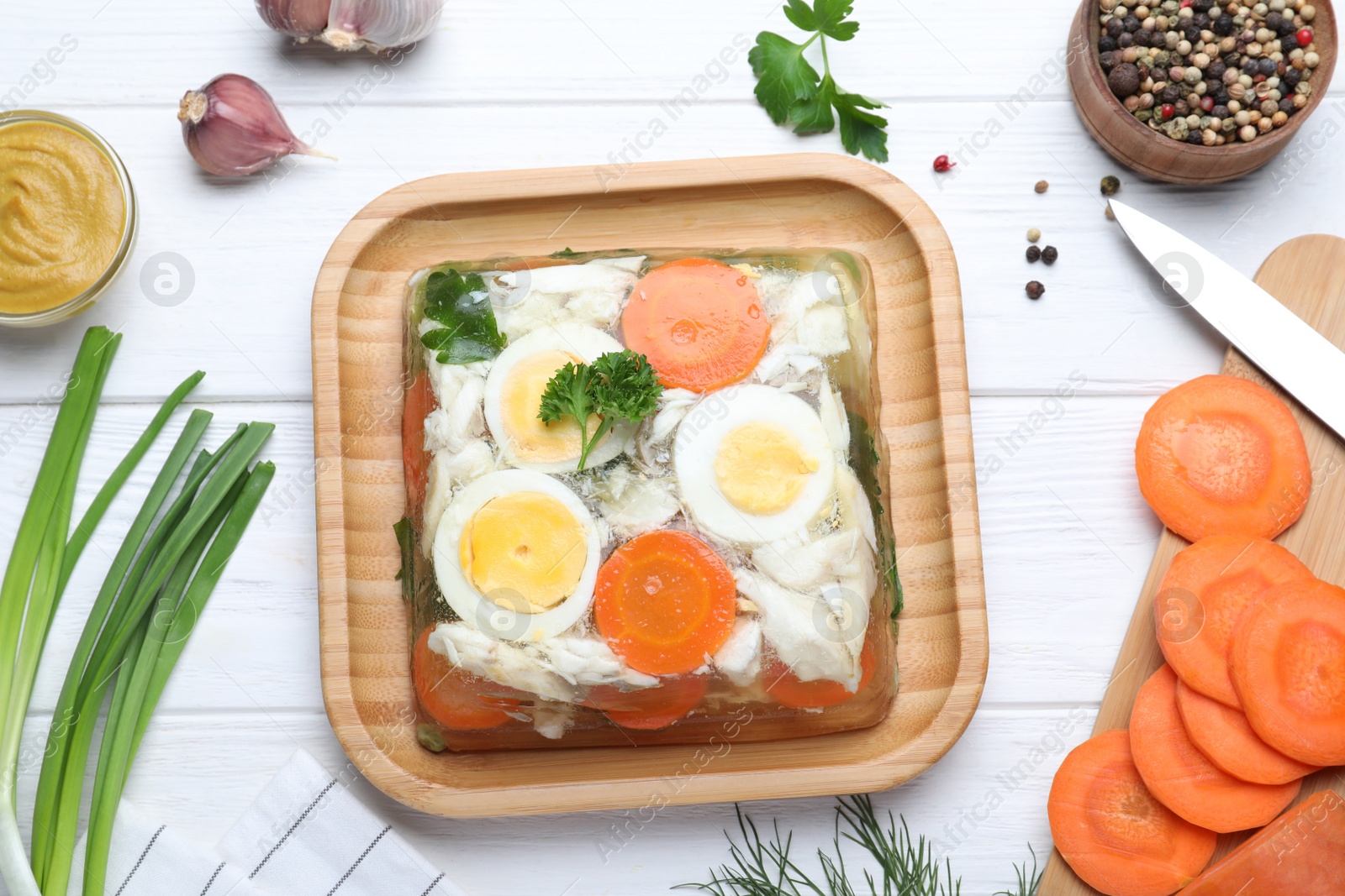 Photo of Delicious fish aspic served on white wooden table, flat lay