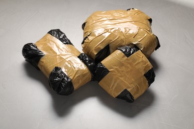Photo of Packages with narcotics on grey textured table