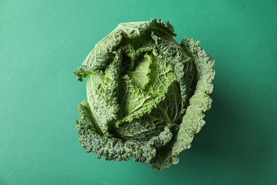 Fresh savoy cabbage on green background, top view