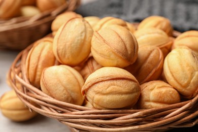 Bowls of delicious nut shaped cookies on white wooden table, closeup