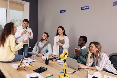 Photo of Team of employees working together in office. Startup project