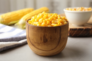 Bowl with corn kernels on grey table