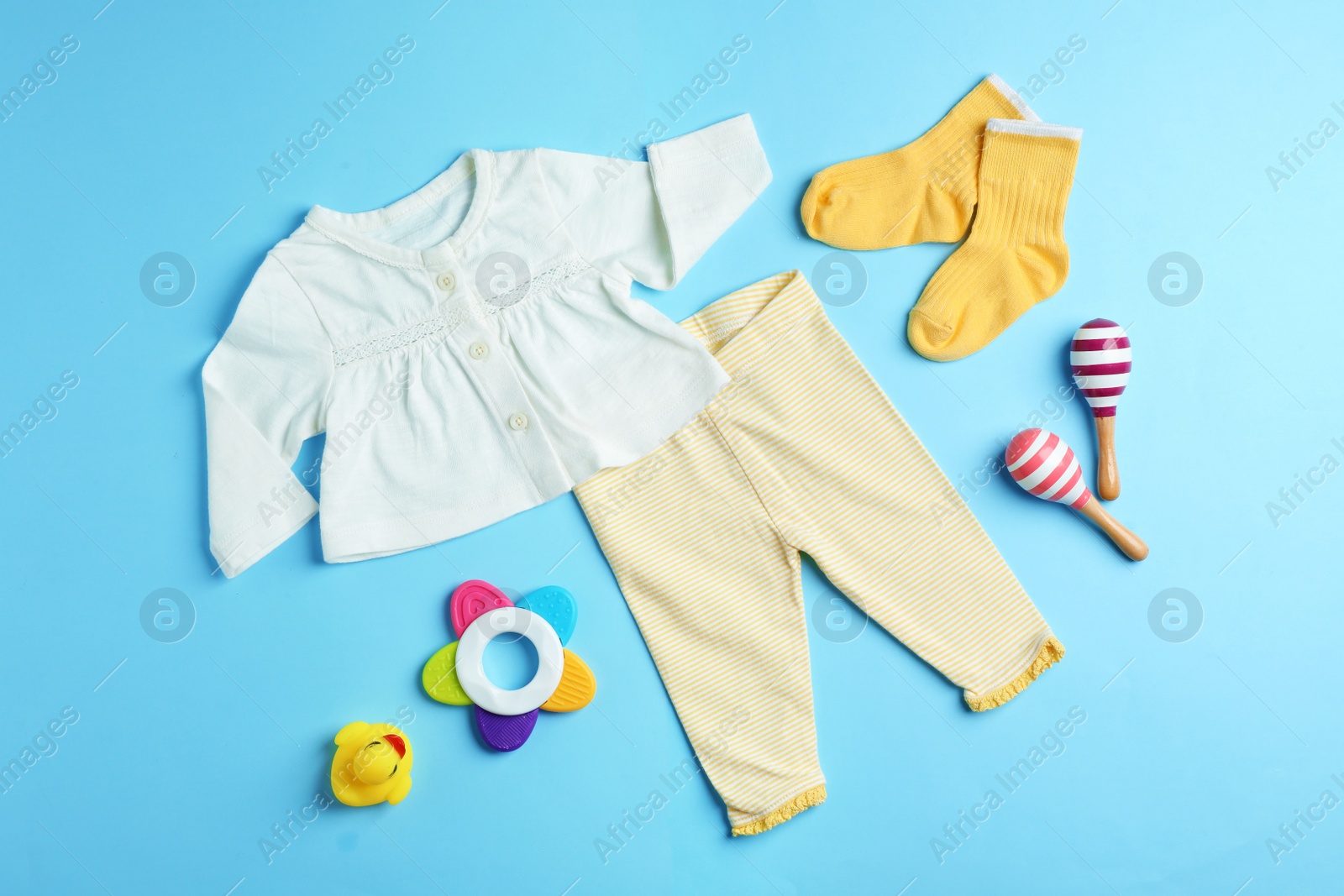 Photo of Flat lay composition with cute clothes on color background. Baby accessories