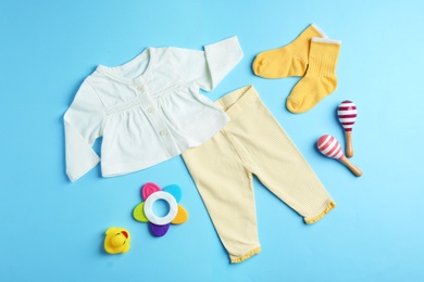 Flat lay composition with cute clothes on color background. Baby accessories