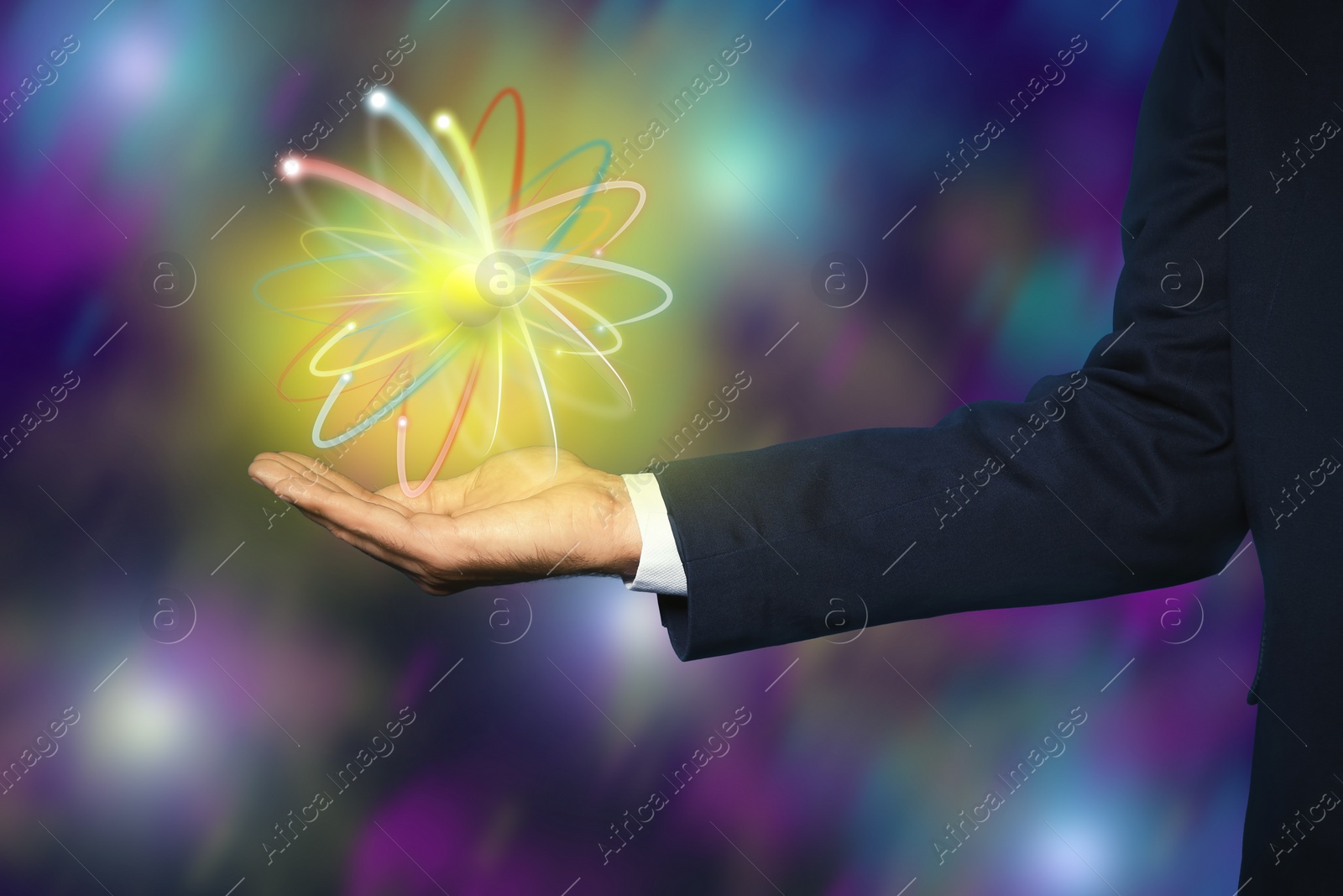 Image of Man holding virtual model of atom on color background, closeup