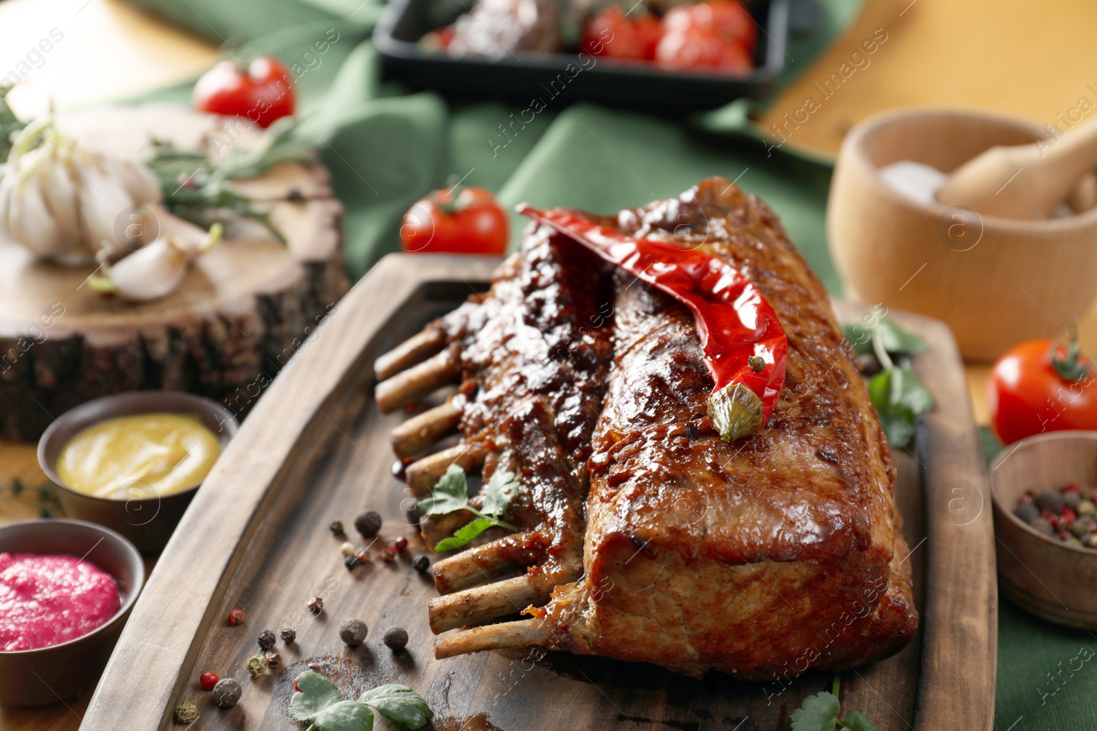 Photo of Delicious roasted ribs served on table, closeup