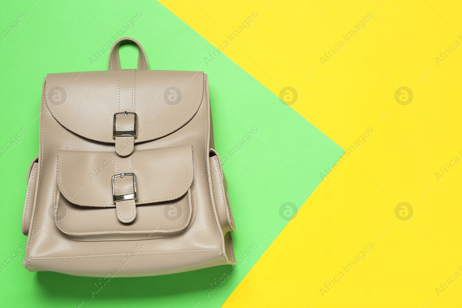 Photo of Stylish urban backpack on color background, top view. Space for text