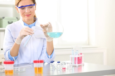 Photo of Female scientist working at table in laboratory, space for text. Research and analysis