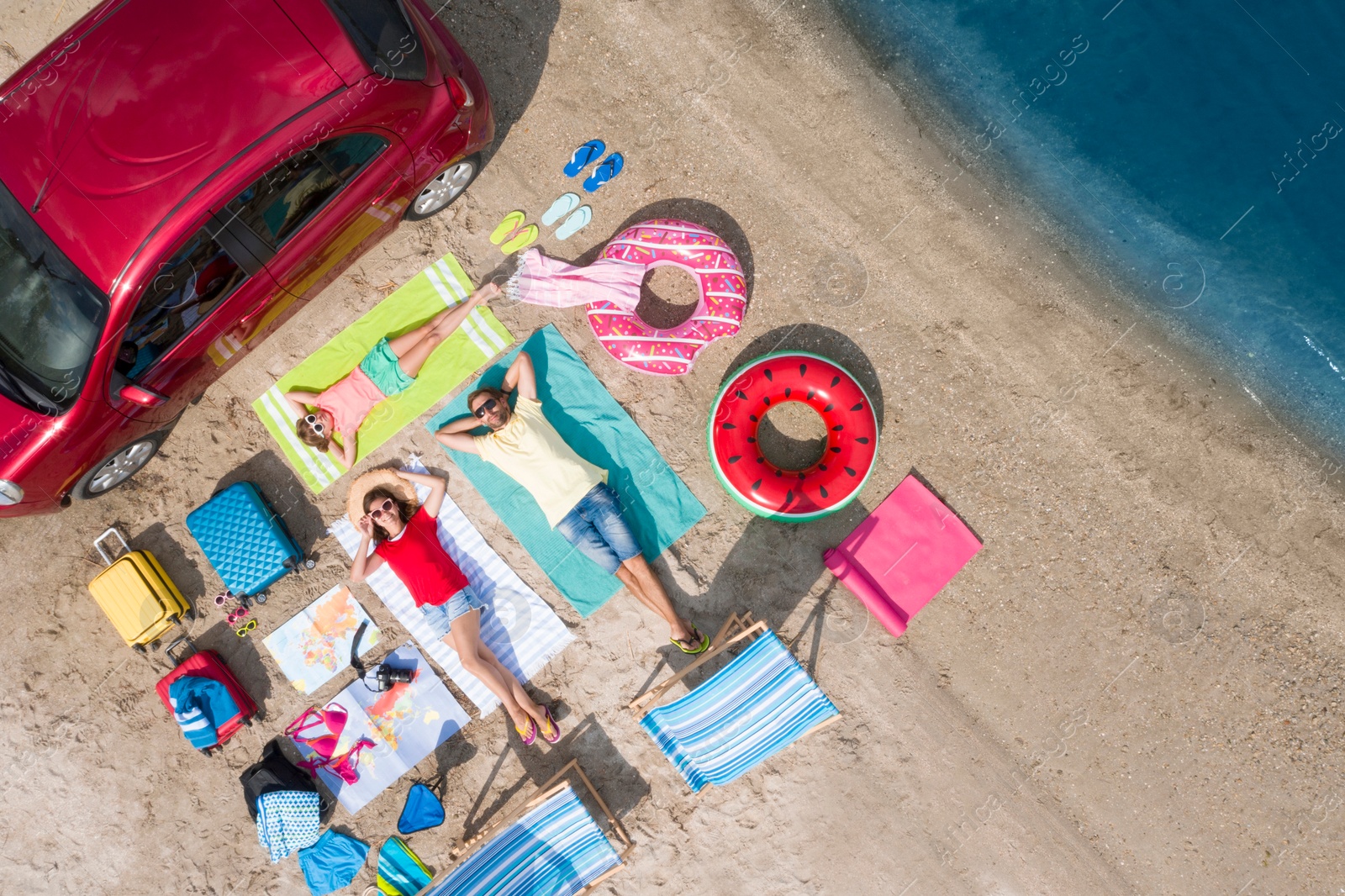 Image of Family with beach accessories and car near river, aerial view. Summer trip