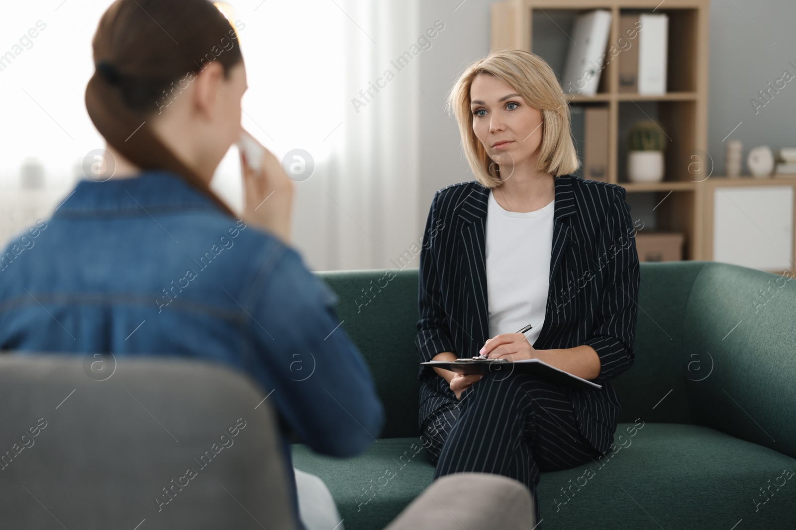 Photo of Professional psychotherapist working with patient in office