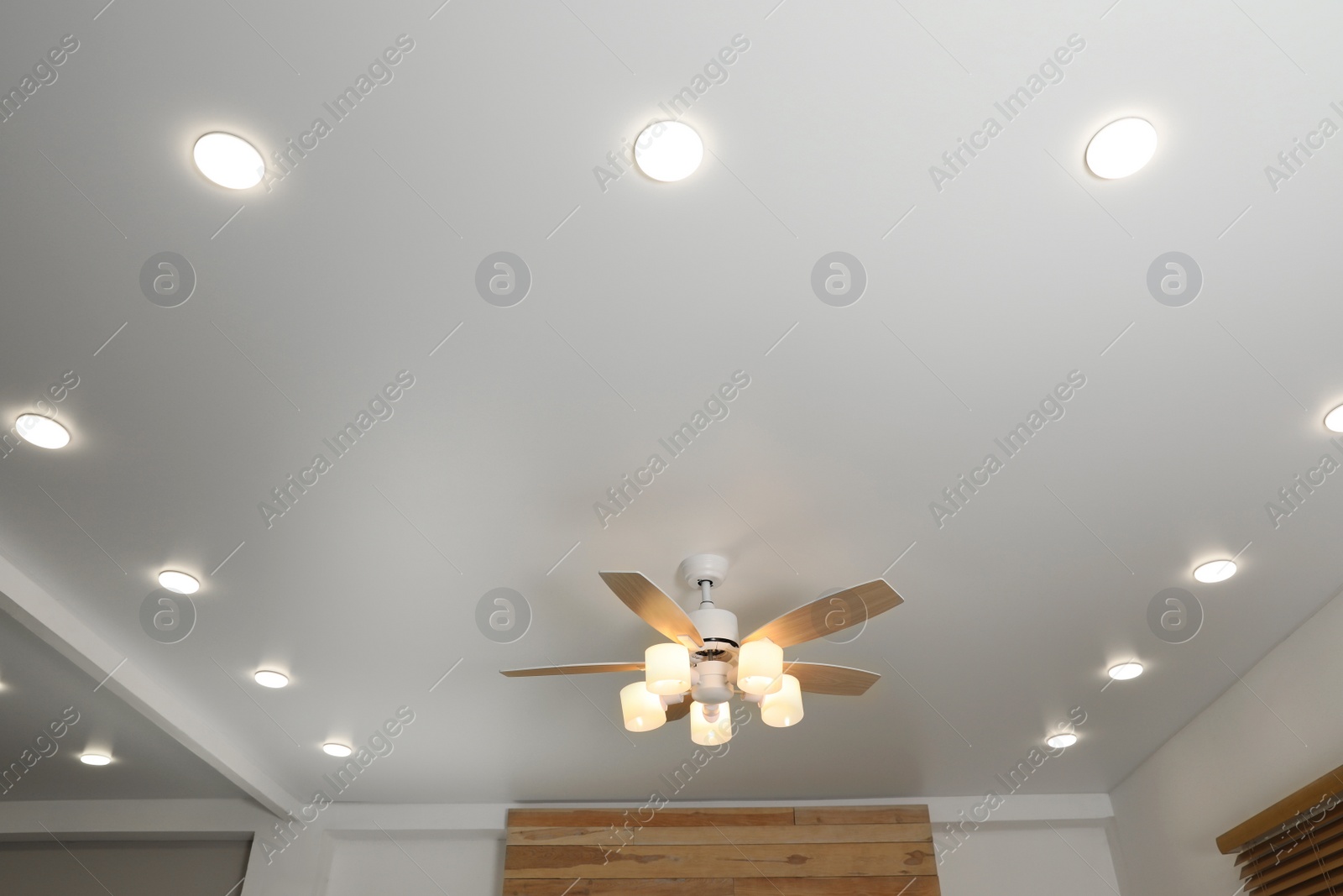 Photo of Modern ceiling fan with lamps indoors, below view