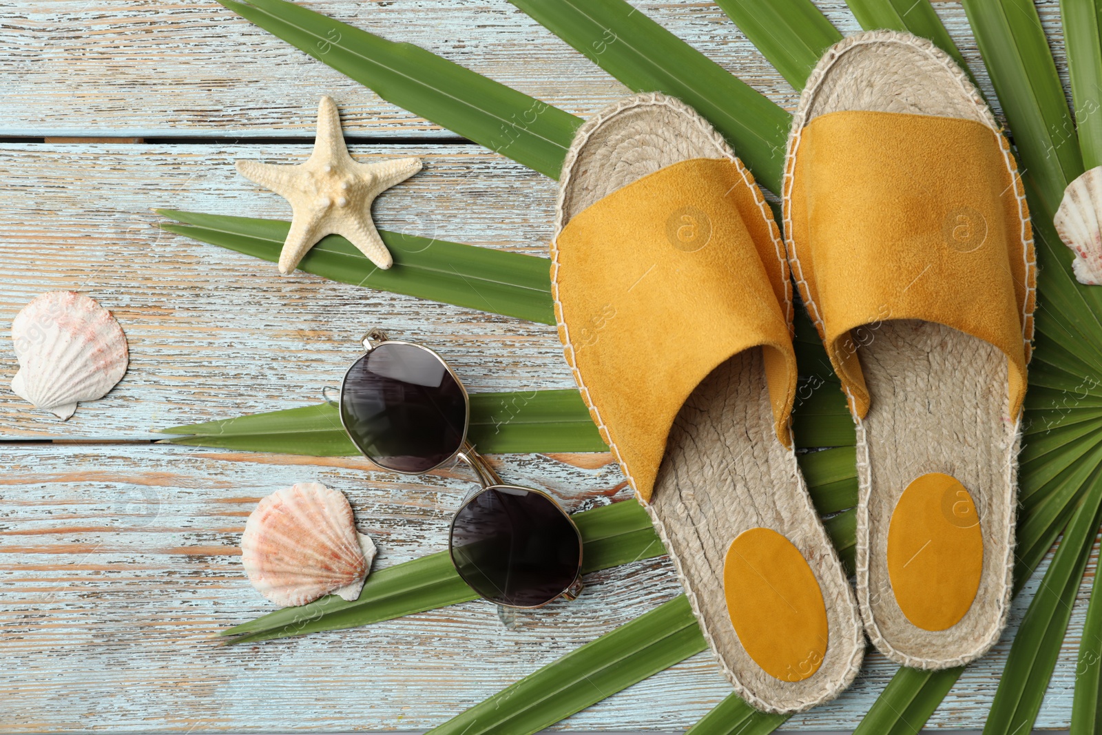 Photo of Beach objects on wooden background, flat lay