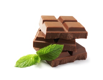 Pieces of milk chocolate with mint on white background