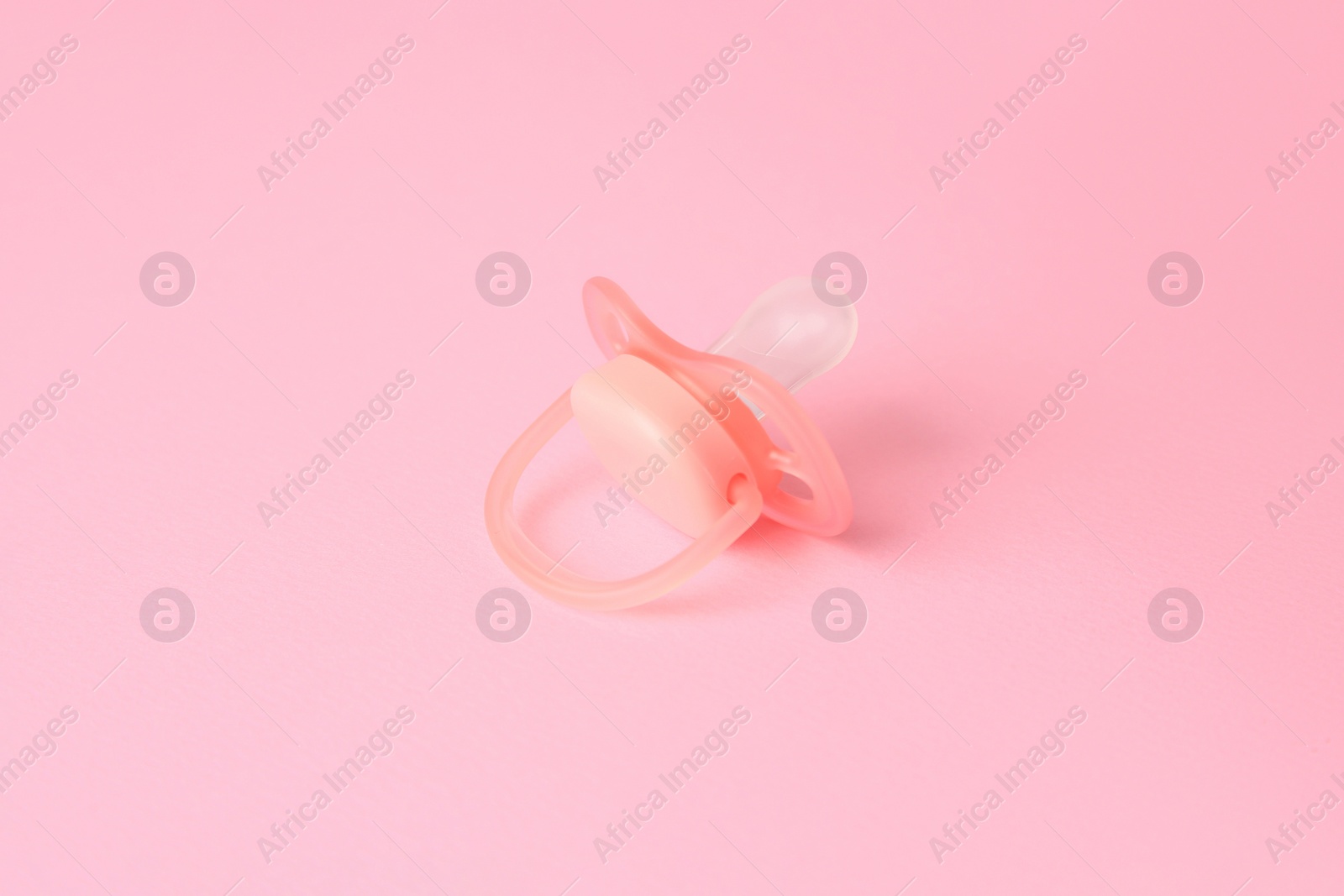 Photo of One new baby pacifier on pink background