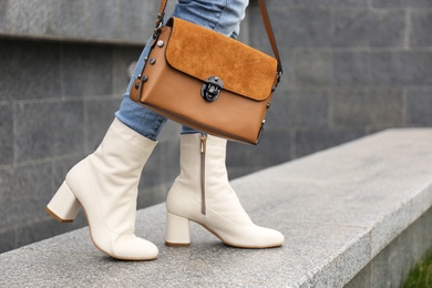 Woman in stylish leather shoes with bag outdoors, closeup