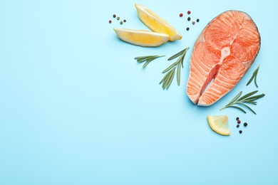 Flat lay composition with salmon steak on blue background. Space for text