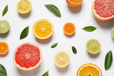 Flat lay composition with different citrus fruits on white background